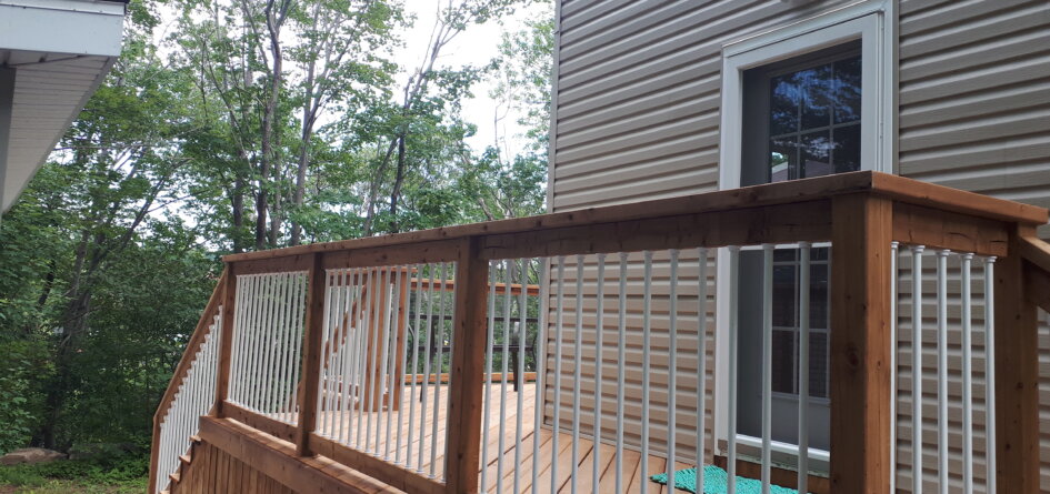 Brown Pressure Treated Deck with White Aluminum Baluster Rail