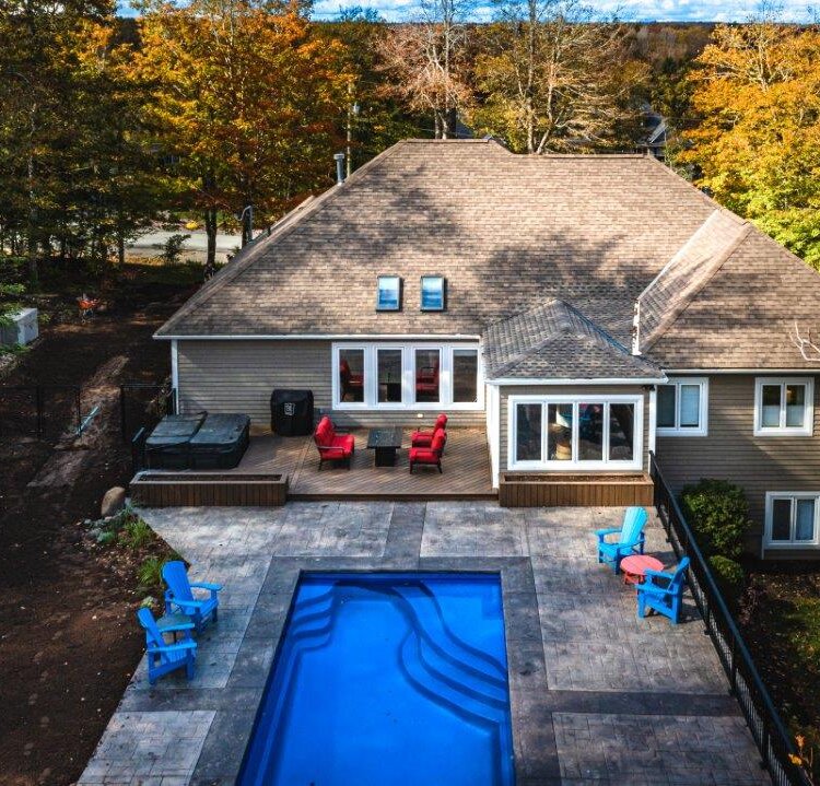 Trex composite deck and sunroom renovation with pool and hardscaping